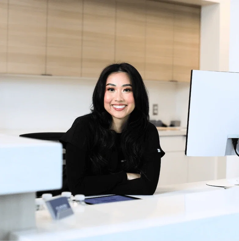 Happy patient with beautiful smile after dental implant treatment